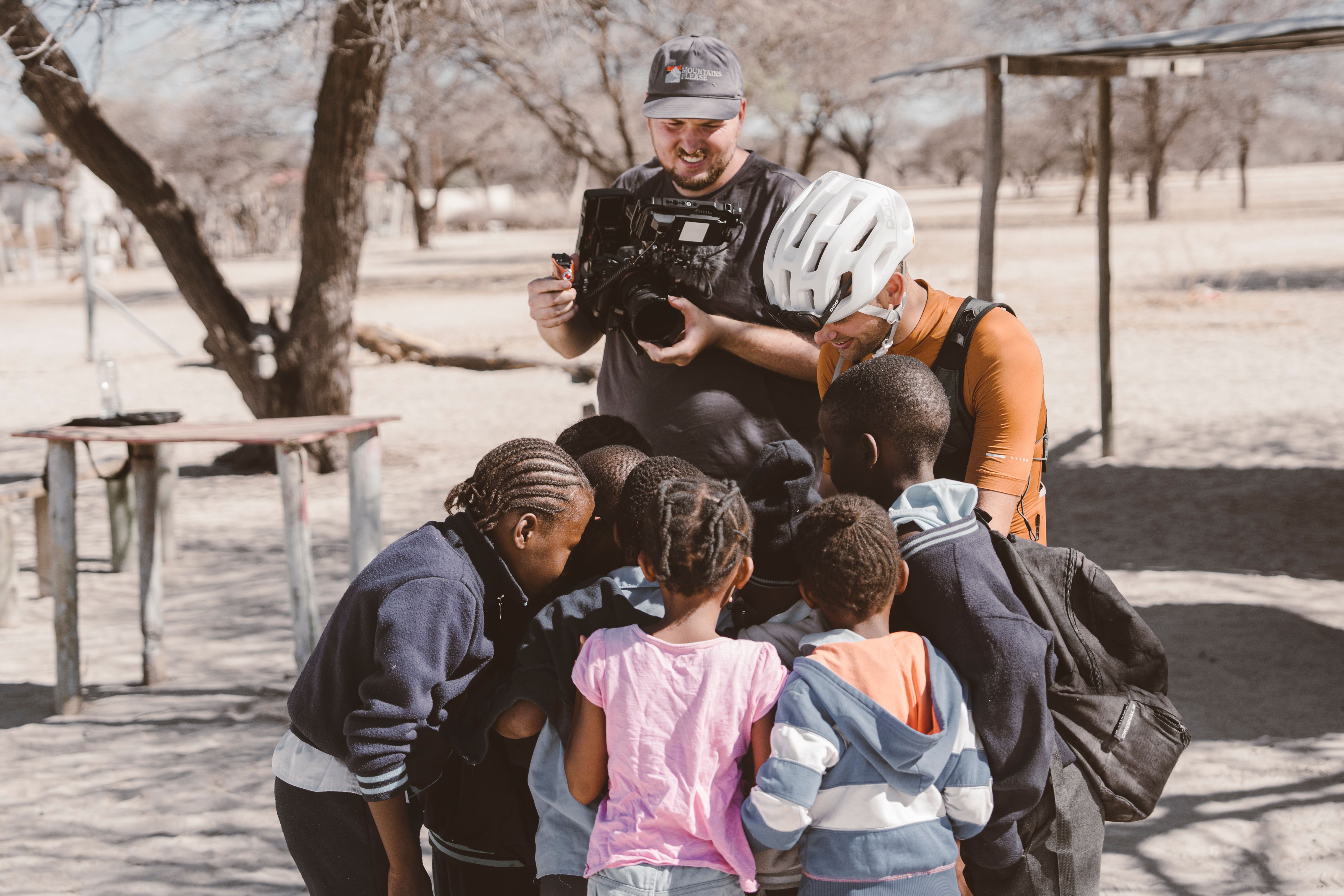 Erik sharing his water with kids in Africa.