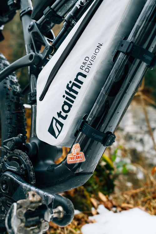 The white Tailfin R&D Division bags have gotten very famous in bikepacking races like Atlas Mountainrace.