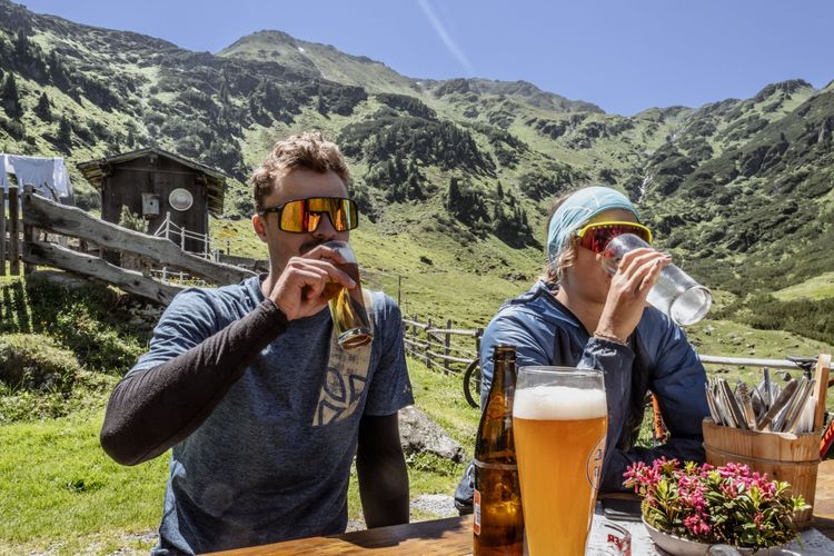 Traditional food on top of an alm hut in the tyrolean alps in Brixental is your reward for riding your bike.