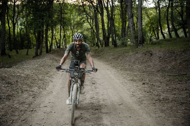 A happy Sofiane in the worlds largest Walnut forest in Kyrgyzstan during the Silkroad Mountainrace.